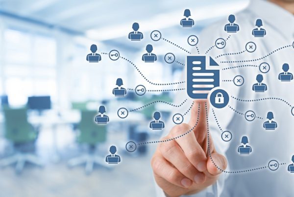 A person in business attire touches a virtual screen displaying connected icons of people and documents, symbolizing electronic document management and network security in a small business office environment.