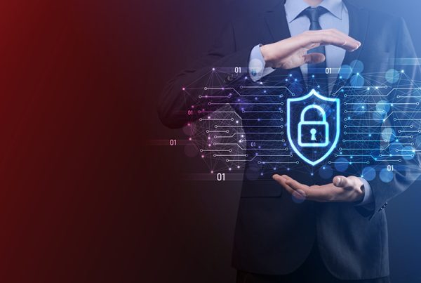 A person in a suit holds their hands around a glowing digital shield with a padlock icon, symbolizing business cybersecurity protection. The background features abstract data and network lines, evoking an ultimate guide to safeguarding information.
