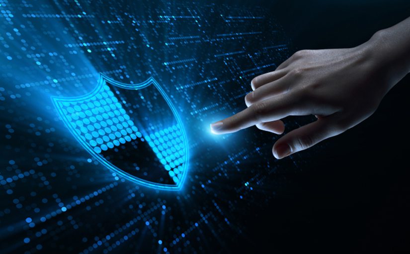 A hand reaching out to touch a glowing digital shield icon, symbolizing cybersecurity or data protection in 2022, with a futuristic blue and black background featuring digital patterns.