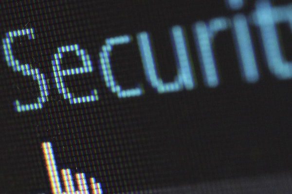 Close-up of a computer screen displaying the word Security with a pointer cursor nearby and a shield icon to the left, highlighting the importance of cybersecurity for businesses.