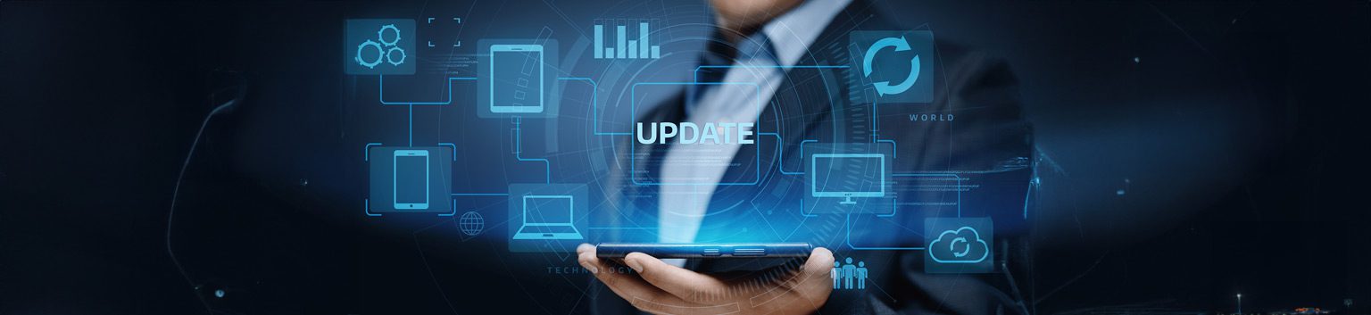A person in a suit holding a tablet with digital icons of devices and graphs floating above it; the word UPDATE appears prominently, highlighting the need to upgrade business tech for modern success.