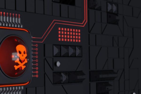 A black computer motherboard with red circuitry features a prominent microchip displaying a glowing red skull and crossbones symbol, highlighting the importance of ransomware protection and vigilance against cybersecurity threats or malware.