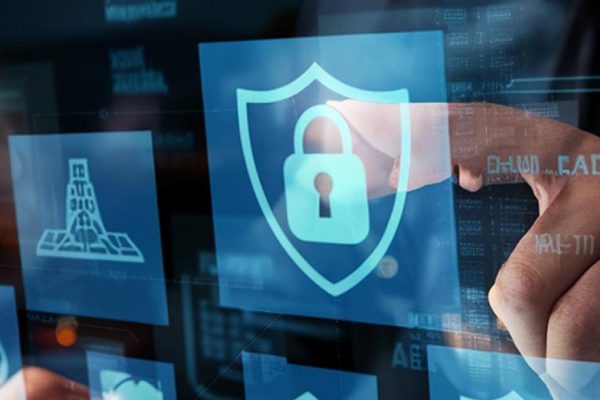 A person interacts with a transparent digital screen displaying various cybersecurity icons, including a shield with a padlock, symbolizing robust business security and online data protection measures.