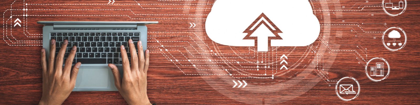Hands typing on a laptop keyboard on a wooden desk, with digital cloud upload icon and technology symbols overlaid, representing the future of cloud computing for small businesses and efficient data transfer.