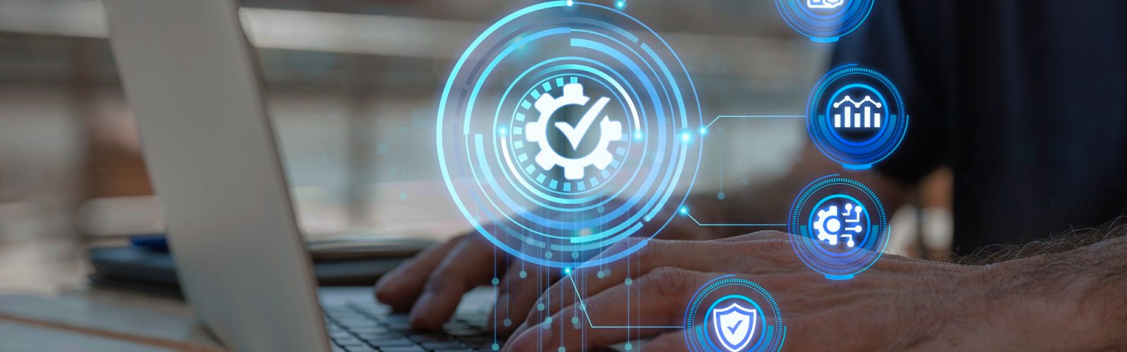 Hands typing on a laptop keyboard with digital icons overlaid, including a checkmark in a gear, graphs, and security symbols, representing Managed IT Services focused on technology, security, and effective data management.