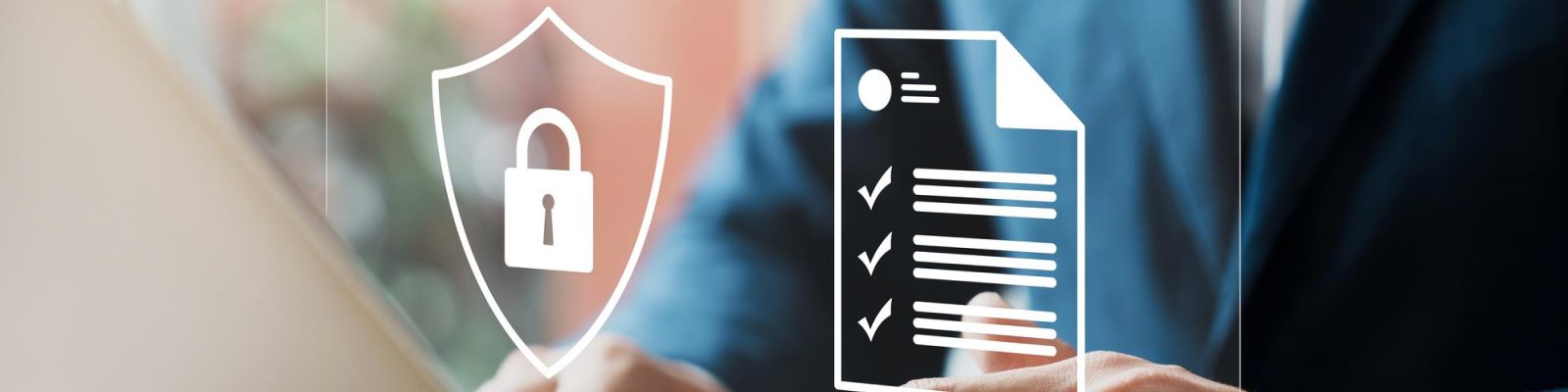 A person in a suit works at a desk with digital icons overlaid, including a shield with a padlock and a checklist, symbolizing security and illustrating the importance of cybersecurity compliance.