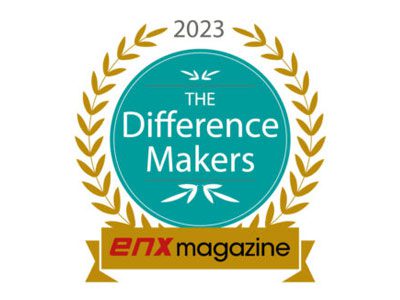 A teal and gold badge reading 2023 The Difference Makers is surrounded by a gold laurel wreath, with ENX Magazine and the Elite Dealers Award showcased in a gold banner at the bottom, highlighting GoodSuite’s recognition.