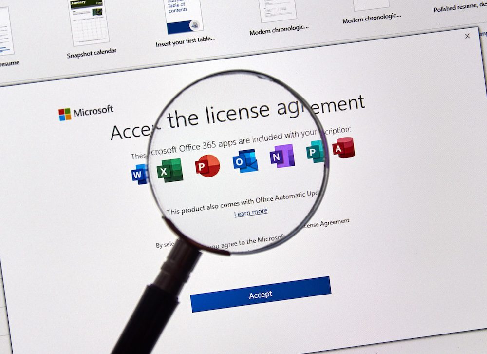 A magnifying glass focuses on a computer screen displaying a Microsoft 365 licensing agreement with icons for Word, Excel, PowerPoint, OneNote, and Outlook, and a blue Accept button below.