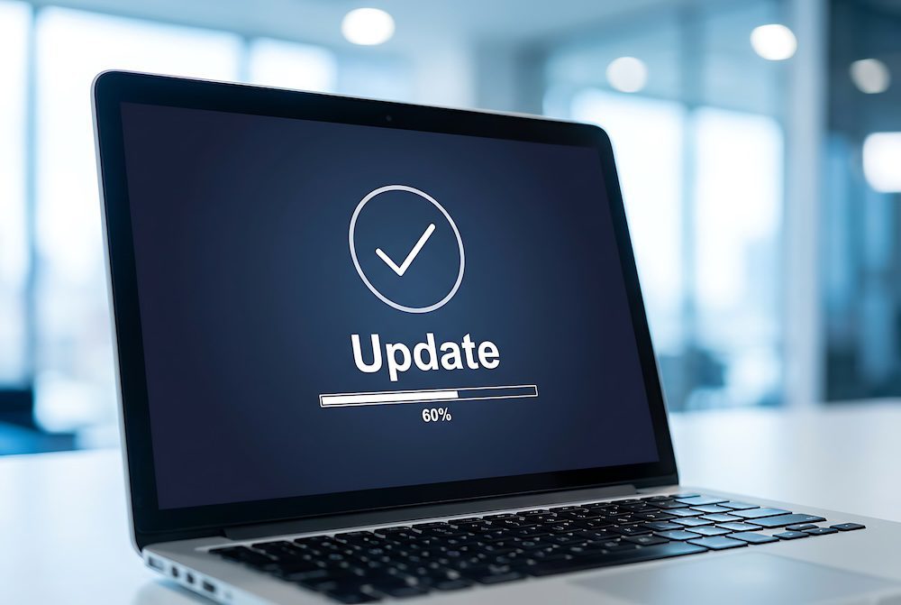 Laptop displaying a software update in progress in a modern office.
